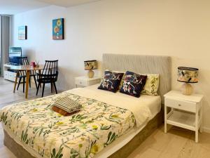 a bedroom with a bed and a dining room at New Town Studio in Sydney