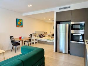 a kitchen and living room with a couch and a table at New Town Studio in Sydney