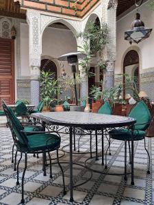 a patio with a table and chairs in a courtyard at Riad Al Bartal in Fez