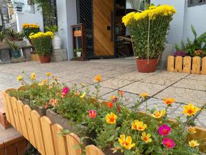 a garden of flowers in front of a building at Kỳ Duyên House in Cái Răng