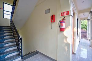 an exit sign on the side of a building with stairs at Casa Nathan in Calangute