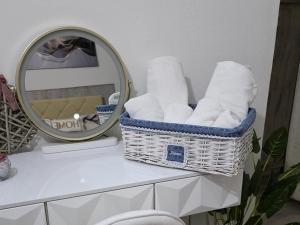 a basket of towels sitting on a counter next to a mirror at Casa Nicole in Assemini