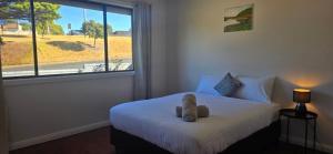 a bedroom with a bed with a large window at Holiday Home in Warrnambool in Warrnambool