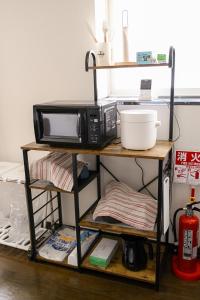 HanazonomachiにあるROOMzero 1号室のテーブルの横の棚に置かれた電子レンジ +20枚の写真