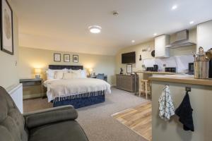a large bedroom with a bed and a kitchen at Curzon St Aparthotel in Derby