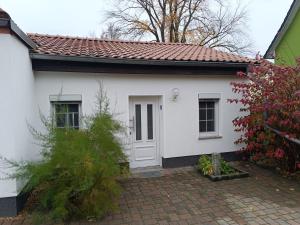 a white house with a red roof at Kastanienhof Lübben in Lübben