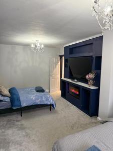 a bedroom with a bed and a tv in a room at North Birmingham in Holly Lane