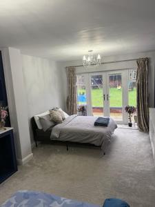 a bedroom with a bed and a large window at North Birmingham in Holly Lane
