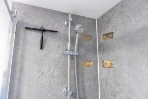 a religious shower with a cross on the wall at Curzon St Aparthotel in Derby