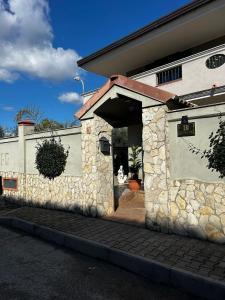 a building with a stone wall with a doorway at Bed and Breakfast Medaglia D'oro in Marcianise