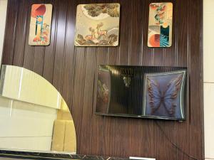 a wall with pictures of a butterfly on it at Hotel rajmahel chotila in Chotila