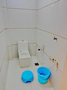 a bathroom with a toilet and a blue bowl at Hotel rajmahel chotila in Chotila
