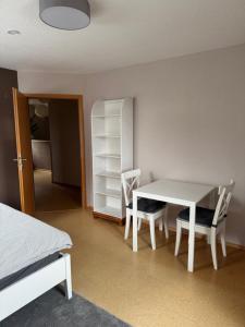 a room with a table and chairs and a bed at Ferienwohnung Schürer in Lauter