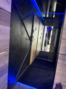 an open elevator door with blue lights in a building at SECRET LOVE studio in Ełk +6 photos