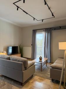 a living room with a couch and a table at B2 Pausilipon Park Corner in Karditsa