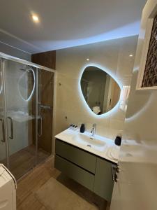 a bathroom with a sink and a shower with a mirror at B2 Pausilipon Park Corner in Karditsa +15 photos
