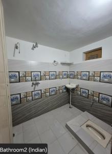 a bathroom with a sink and a urinal at Shree Govindam kunj Villa in Jaipur