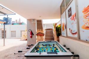 a pool table on the patio of a house at Residence Next Door Sunset in Kiambu
