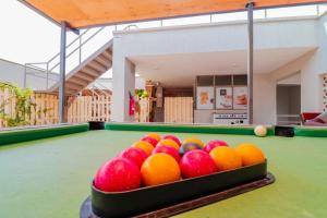 a bowl of bowling balls on a pool table at Residence Next Door Sunset in Kiambu