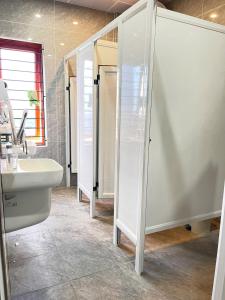 a bathroom with a sink and a toilet and a mirror at The Sun Backpacker Hostel in Ninh Binh +26 photos