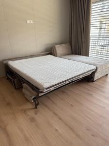 a hospital bed in a room with a wooden floor at ApartmanBrezovina217 in Veselé