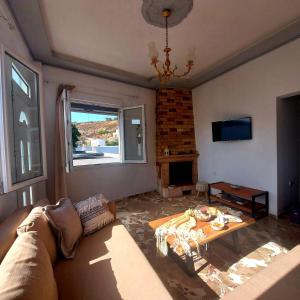 a living room with a couch and a table at Calliope #1 in Skala