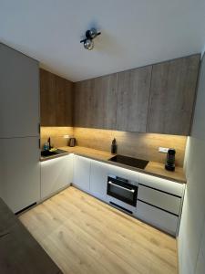 a kitchen with white cabinets and a ceiling fan at ApartmanBrezovina217 in Veselé