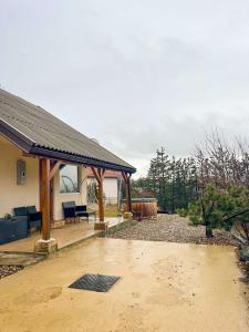 a house with a porch and a patio at Vila Xenos Loft Karakter Zlatibor in Zlatibor