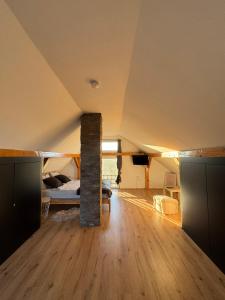 a room with a bedroom and a bed in a attic at Vila Xenos Loft Karakter Zlatibor in Zlatibor