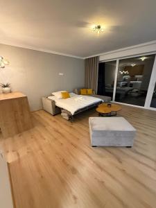 a living room with two beds and a table at ApartmanBrezovina217 in Veselé