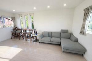 a living room with a couch and a table at Saraswati in Nakijin