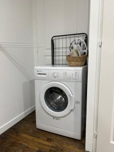 a washing machine with a basket on top of it at Le Lido Maison 6 personnes in Saint-Varent +3 photos
