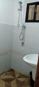 a bathroom with a shower and a sink at Mangas Residents shared room in El Nido Airport