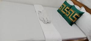 a bed with a book and a stuffed animal on it at Mangas Residents shared room in El Nido Airport