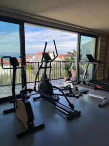 a gym with several tread machines in front of a large window at Hotel Kali in Kali