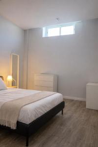 a bedroom with a large bed and a window at Zena Park - Near Lisbon in Odivelas