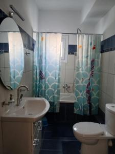 a bathroom with a sink and a toilet and a shower at Ioana Sea View in Corfu +18 photos