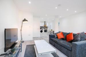 a living room with a couch and a table at Luxurious 1 Bed Serviced Apartment with Wi-Fi in Corby +84 photos
