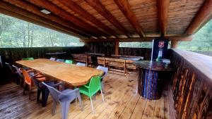 a dining area of a cabin with wooden tables and chairs at Cămăruța din Apuseni in Valea Ierii
