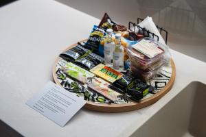a basket filled with food and drinks on a table at Modern City Studio with Balcony Columbus Apartment in Chios