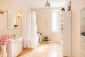 a bathroom with a shower curtain and a sink at Family Hotel Daugavpils in Daugavpils +43 photos