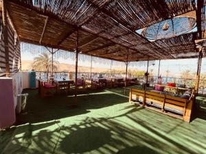 a pavilion with a table and chairs on a patio at Bayt Zaina Nile View in Aswan