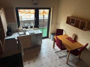 a kitchen with a wooden table and a table and chairs at Ferienwohnung "Casa Horife" in Konz