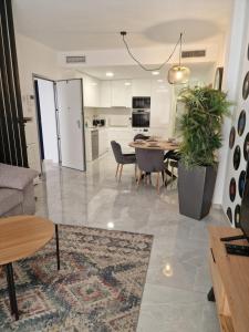 a kitchen and living room with a table and chairs at Lassa Holiday Apartament in Torrevieja