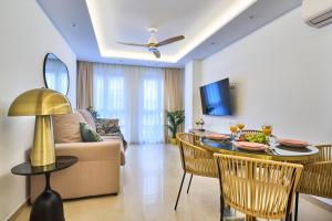 a living room with a couch and a table with food on it at Malagueta Loft & Sea in Málaga