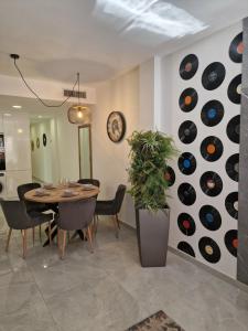 a dining room with a table and a wall of records at Lassa Holiday Apartament in Torrevieja +11 photos