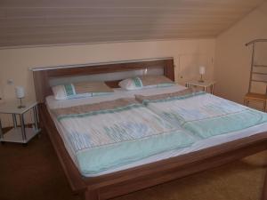 a large bed with two pillows on top of it at Ferienwohnung "Casa Horife" in Konz