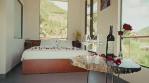 a bedroom with a bed and a table with wine glasses at Homestay Minano in Mock Den