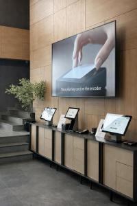 a projection screen on a wall in a lobby at Premier Sofia Airport Hotel in Sofia