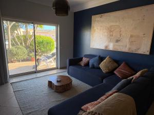 a living room with a blue couch and a table at Fairviews Boavista , Boavista golf and spa resort Lagos in Lagos